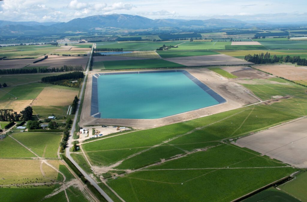 Aerial photo of Sheffield Reservoir. A square body of water surrounded by green grass.
