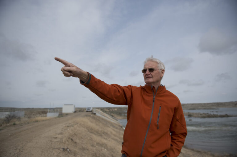 Photo of Brian Olmstead pointing to the left